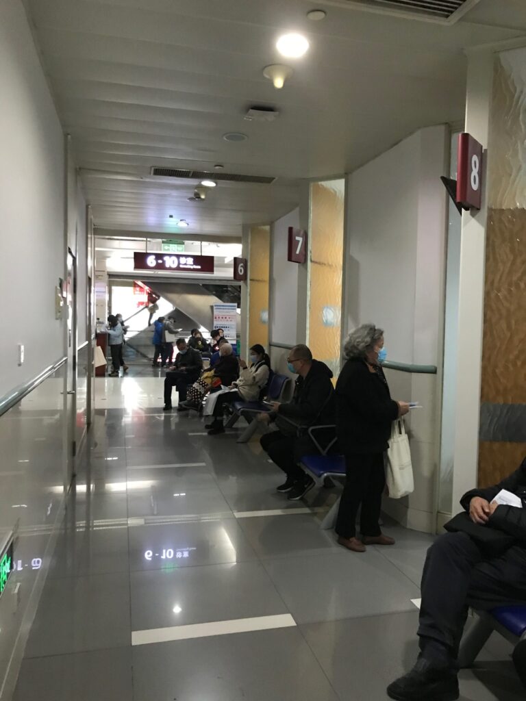 People waiting near the examination rooms in a Chinese public hospital. onaroadtonowhere.com