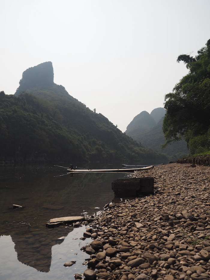 A boat by the river in Yangshuo, China - onaroadtonowhere.com
