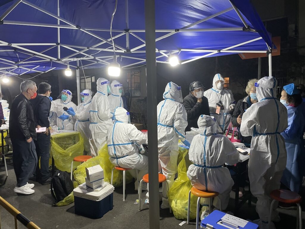 Medical workers carry out nucleic acid tests during China's most recent COVID-19 outbreak. onaroadtonowhere.com
