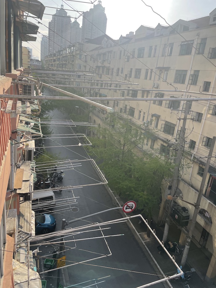 Empty street in Shanghai during shutdown. onaroadtonowhere.com