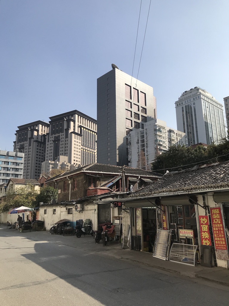 Old Chinese buildings in front of modern skyscrapers in Shanghai