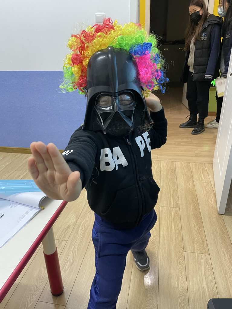 Chinese English student dressed up like clown Darth Vader