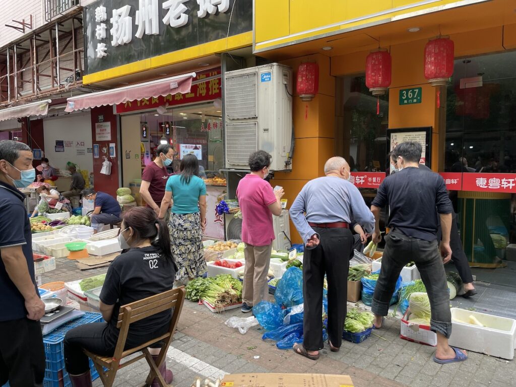 People shop outside a supermarket after Shanghai's lockdown was lifted