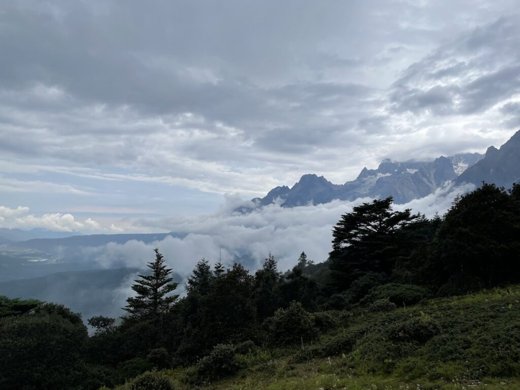 Clouds rolling from peaks at Jade Dragon Snow Mountain in Lijiang, Yunnan, China