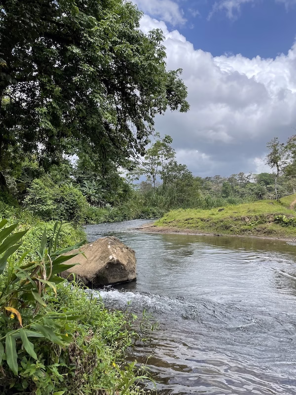 A river flows through the green countryside surrounding Bijagua, Costa Rica