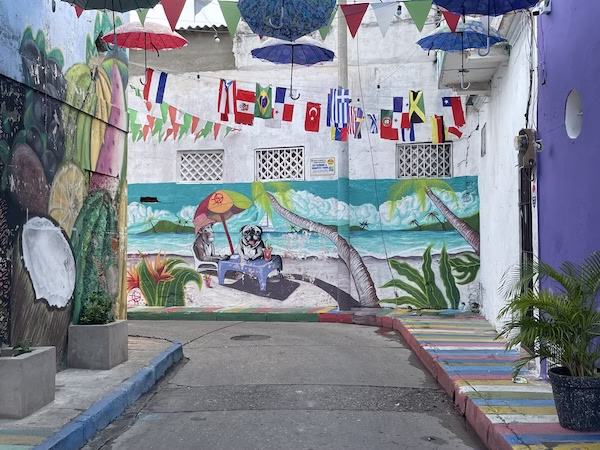 A painted mural and flags above a street