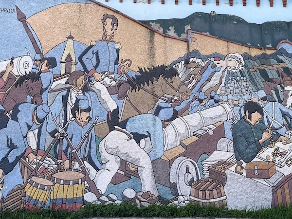 A mural depicting Simon Bolivar leading an army