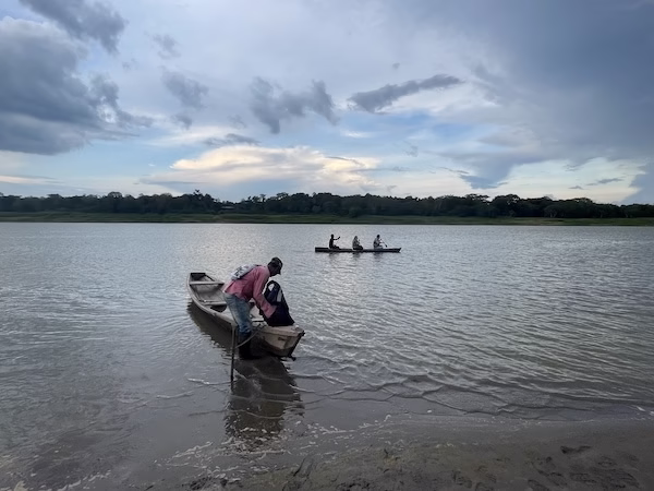 A man prepares a canoe in the Amazon river