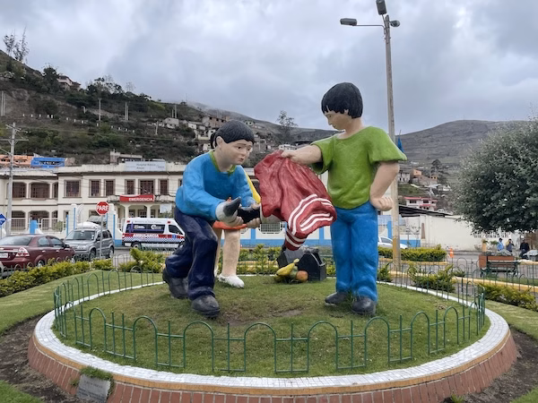 A statue of boys pretending to be bullfighters near the bus station in Alausí, Ecuador