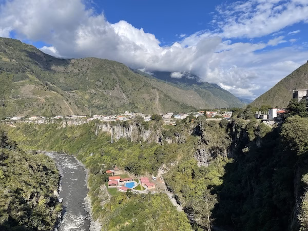 Baños, Ecuador, overlooking a deep gorge with a river at the bottom.