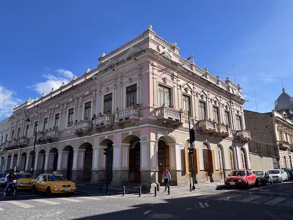 Colonial style building painted pink.