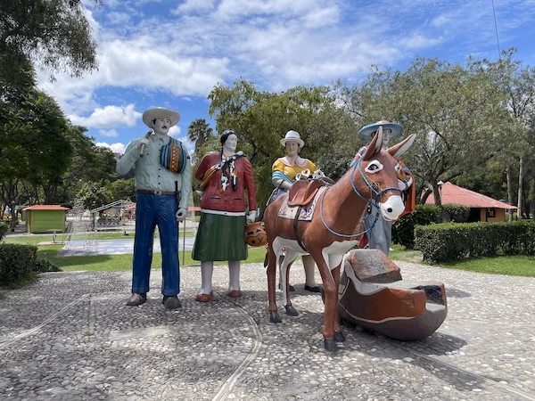 A statue of traditional Ecuadorian farmers and a donkey