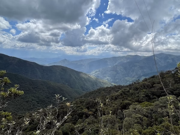 A cloudy sky over green mountains in Podocarpus National Park