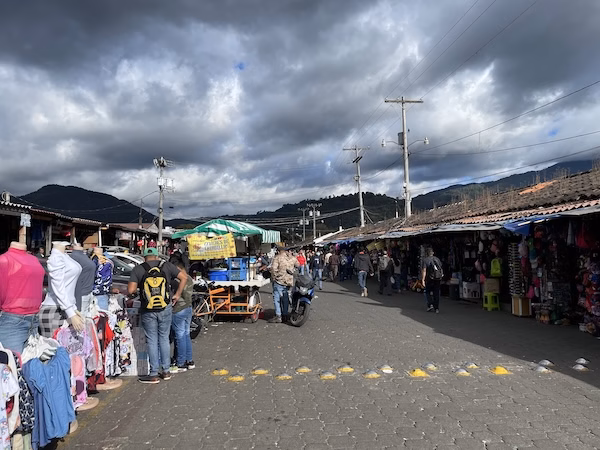 People shop for clothes in the local market in Antigua, Guatemala