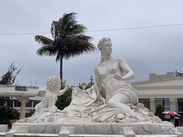 A statue of a nude woman and a baby in Chiclayo, Peru