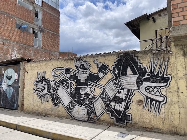 A mural depicting a Native American figure riding a snake in Peru