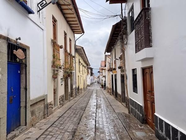 A narrow street lined with Spanish colonial buildings in Cusco