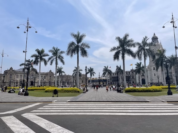 The Plaza de Armas, surrounded by palm trees and colonial buildings