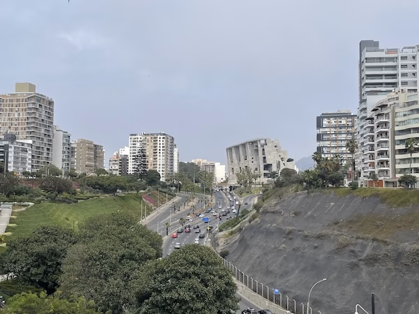 Modern highrises over cliffs and a highway in Lima, Peru