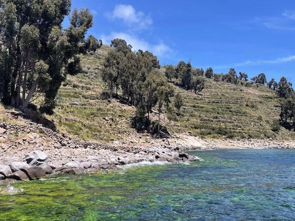 Green and blue water on the shore of Taquile Island on Lago Titicaca